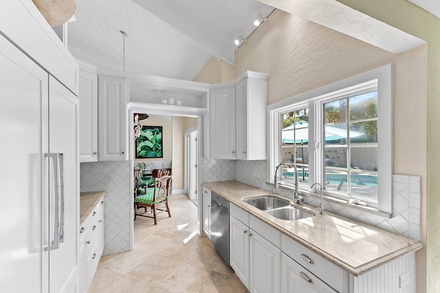 kitchen featuring paneled built in refrigerator, sink, and white cabinets