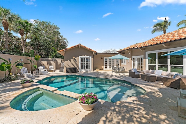 view of pool featuring a patio, an outdoor living space, french doors, and an in ground hot tub