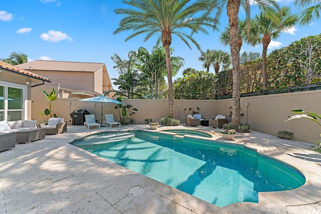 view of swimming pool featuring an in ground hot tub, a grill, an outdoor hangout area, and a patio