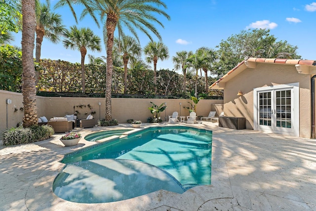 view of pool featuring a patio, outdoor lounge area, and french doors