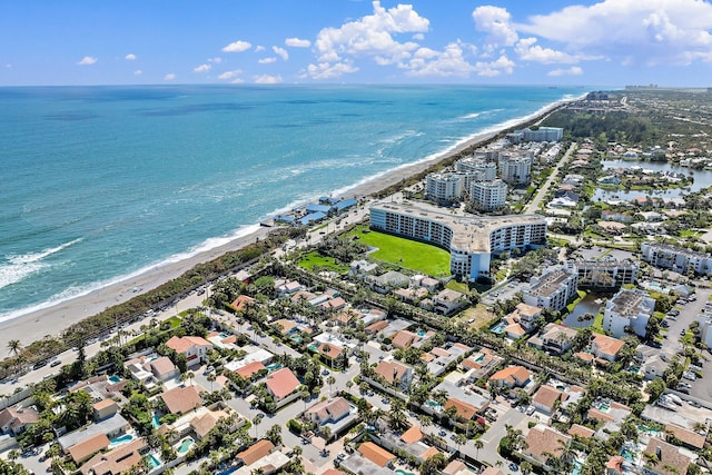 bird's eye view with a water view and a beach view