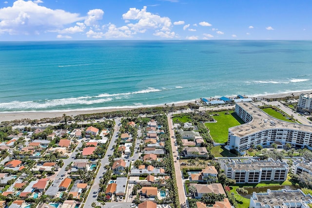 aerial view with a water view and a beach view