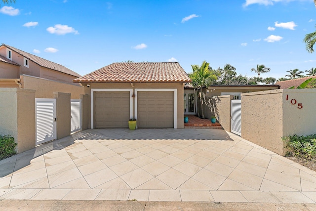 mediterranean / spanish home featuring a garage