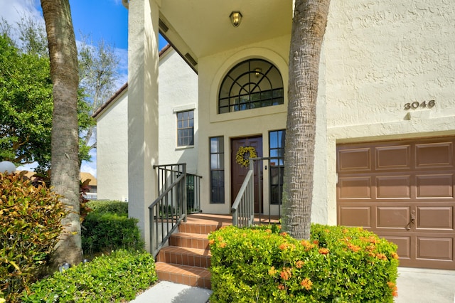 doorway to property with a garage