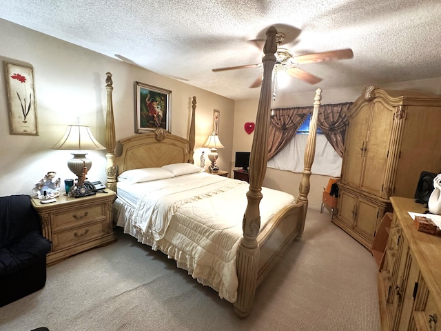 bedroom with light carpet, ceiling fan, and a textured ceiling