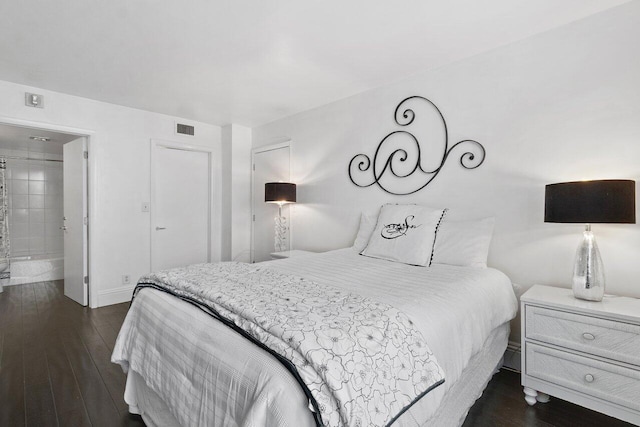 bedroom with dark hardwood / wood-style flooring