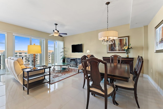 155 Ocean Ave Unit 603, Palm Beach Shores, FL 33404 - dining area with healthy amount of natural light, a chandelier, a ceiling fan, and light tile patterned floors