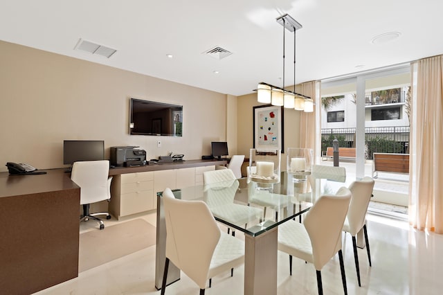 dining room featuring floor to ceiling windows and built in desk