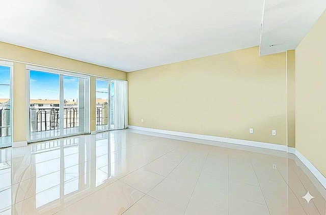 155 Ocean Ave Unit 603, Palm Beach Shores, FL 33404 - spare room featuring baseboards and light tile patterned floors