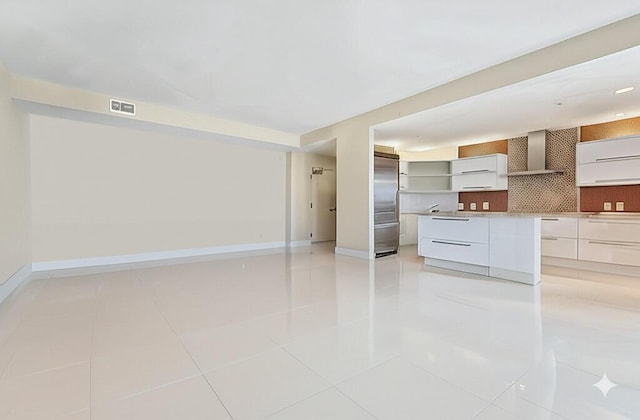 155 Ocean Ave Unit 603, Palm Beach Shores, FL 33404 - unfurnished living room featuring light tile patterned flooring and baseboards