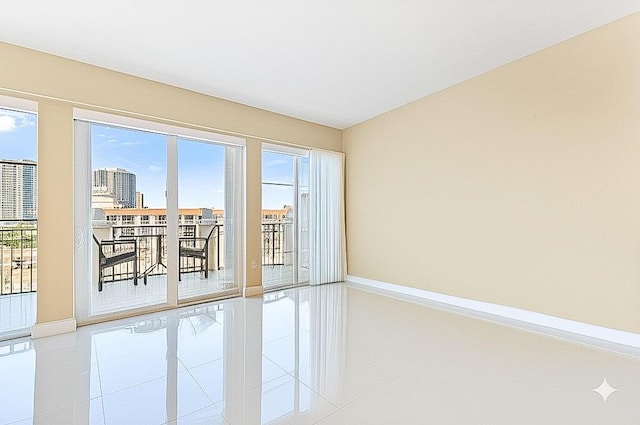 155 Ocean Ave Unit 603, Palm Beach Shores, FL 33404 - spare room featuring baseboards and tile patterned flooring