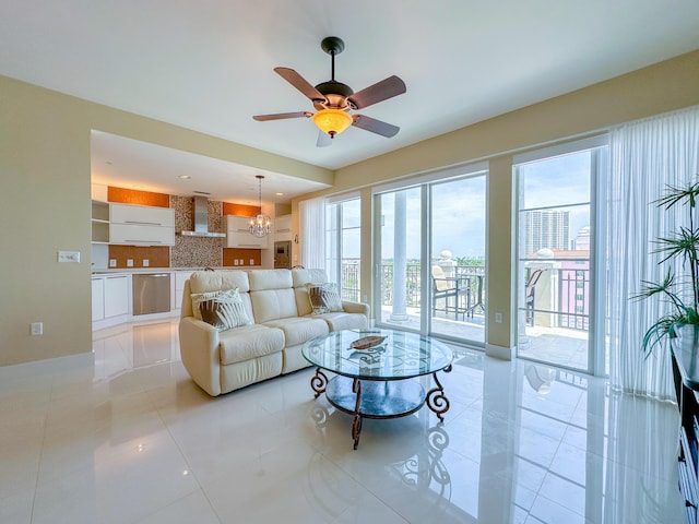 155 Ocean Ave Unit 603, Palm Beach Shores, FL 33404 - living room featuring light tile patterned floors, ceiling fan, and a chandelier