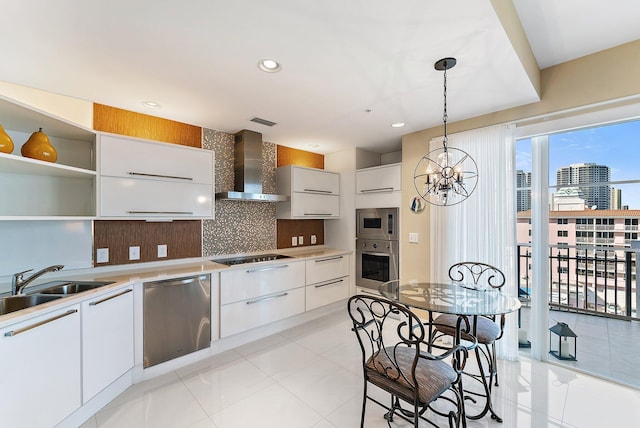 155 Ocean Ave Unit 603, Palm Beach Shores, FL 33404 - kitchen with wall chimney exhaust hood, stainless steel appliances, a sink, decorative backsplash, and light tile patterned flooring