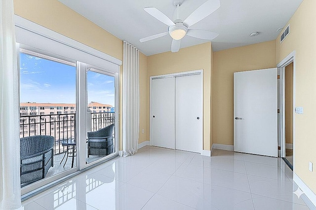 unfurnished bedroom featuring a closet, access to exterior, baseboards, and visible vents
