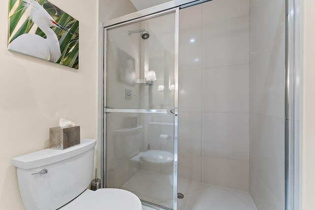 full bathroom with a stall shower and toilet