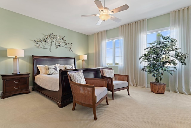 bedroom with light carpet and ceiling fan