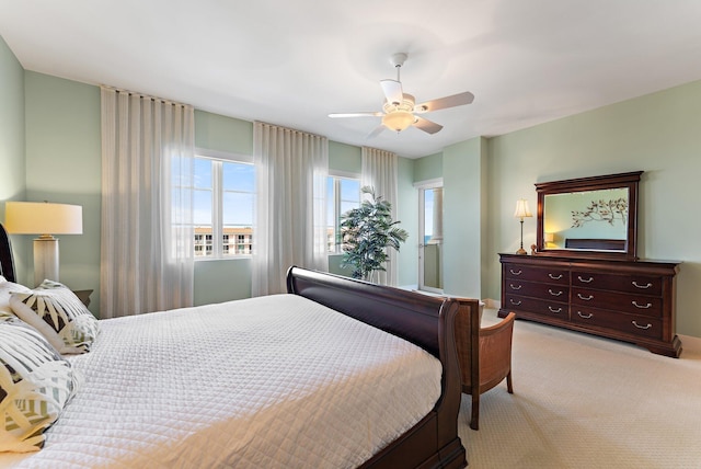 bedroom featuring light colored carpet and ceiling fan