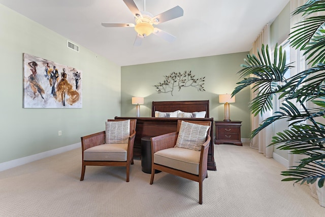 bedroom featuring light carpet, baseboards, a ceiling fan, and visible vents
