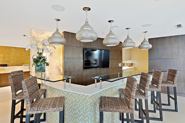 bar featuring decorative light fixtures and visible vents