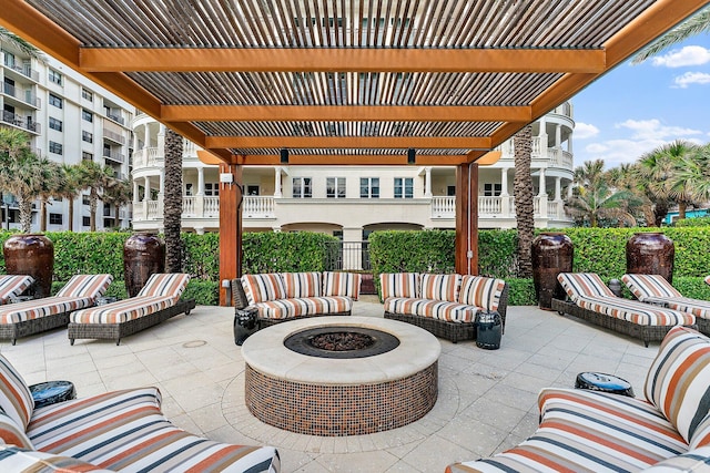 view of patio / terrace with an outdoor living space with a fire pit