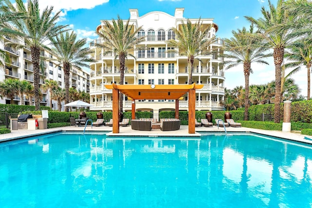 community pool featuring a patio and fence
