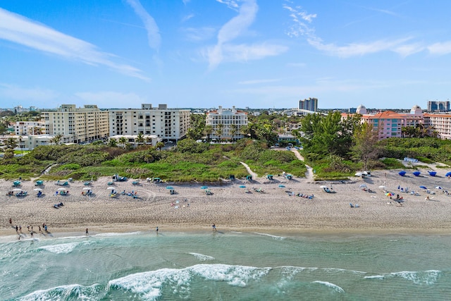 drone / aerial view featuring a water view and a view of the beach