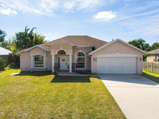 view of front of house with a garage and a front lawn