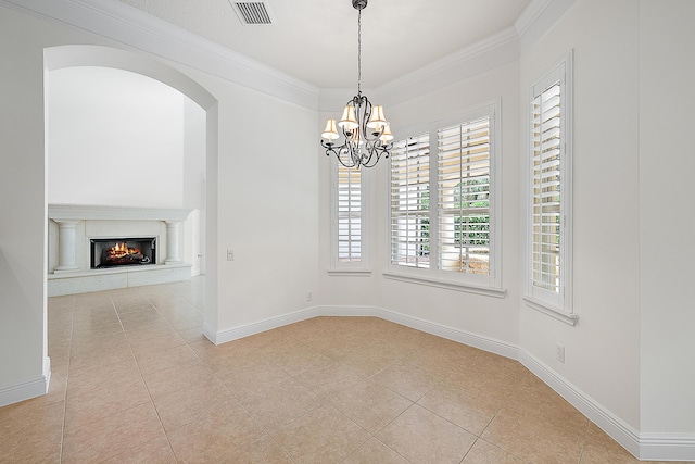 spare room with ornamental molding, visible vents, a premium fireplace, and light tile patterned flooring