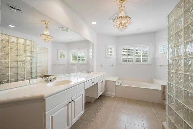 full bath with a garden tub, a sink, visible vents, and tile patterned floors