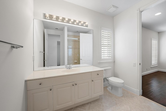 full bathroom featuring baseboards, visible vents, toilet, tile patterned floors, and vanity