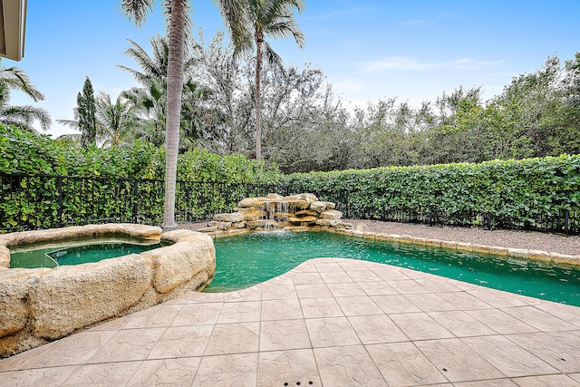 view of pool with a patio area, a fenced backyard, and a pool with connected hot tub