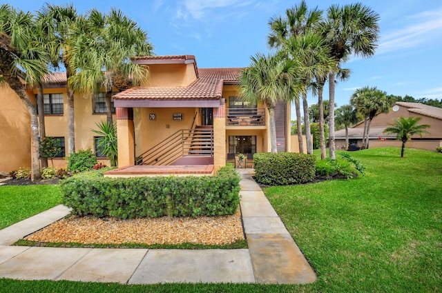 mediterranean / spanish-style house featuring a front yard