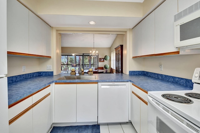 kitchen with white cabinetry, white appliances, a chandelier, and light tile patterned floors