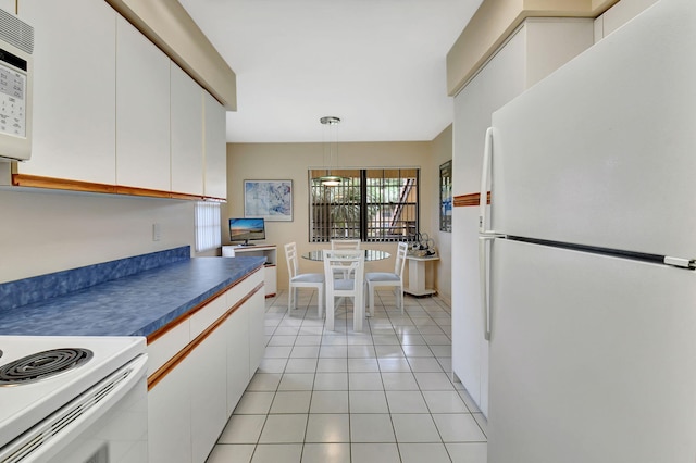 kitchen with pendant lighting, white appliances, light tile patterned flooring, and white cabinets