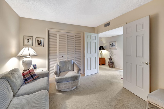 living room with carpet floors and a textured ceiling