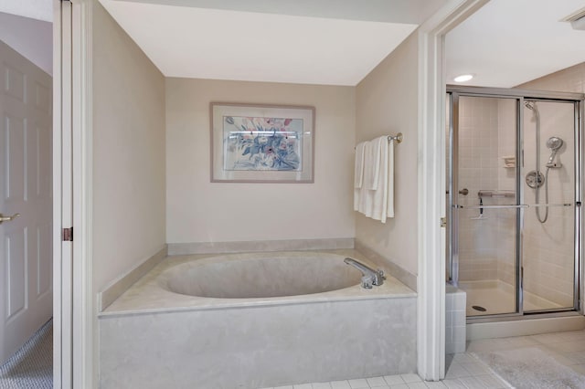 bathroom featuring tile patterned floors and shower with separate bathtub