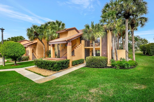 mediterranean / spanish home with a front yard