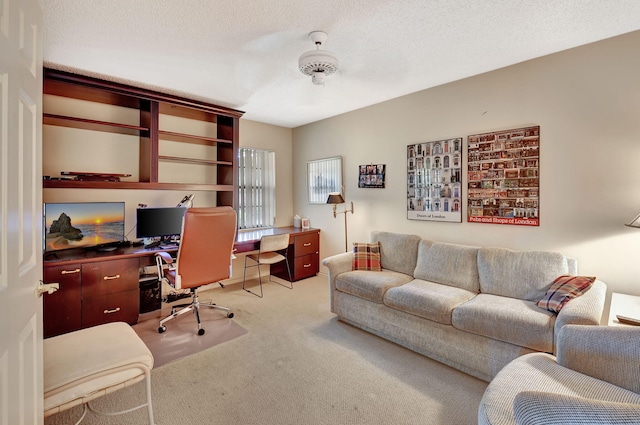 carpeted home office with a textured ceiling