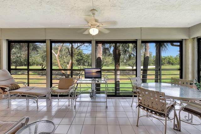 unfurnished sunroom featuring ceiling fan