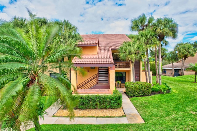 mediterranean / spanish-style home with a front yard