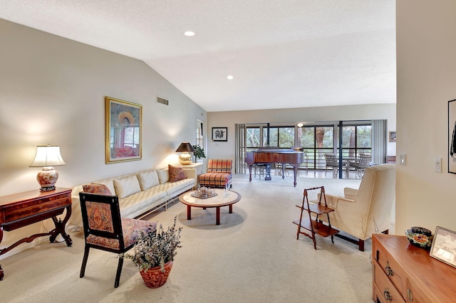 carpeted living room with vaulted ceiling