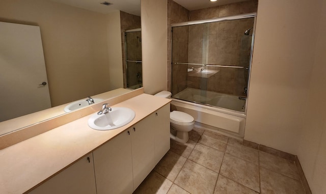 1551 N Flagler Dr Ph L7, West Palm Beach, FL 33401 - bathroom featuring toilet, vanity, bath / shower combo with glass door, and tile patterned flooring