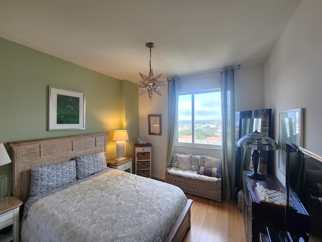 1551 N Flagler Dr Ph L7, West Palm Beach, FL 33401 - bedroom with wood-type flooring and a chandelier