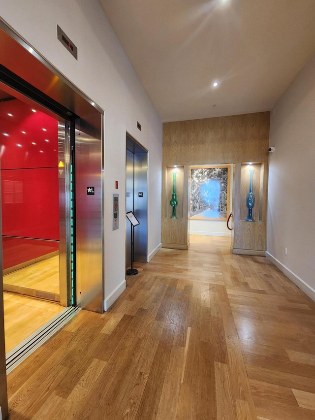 1551 N Flagler Dr Ph L7, West Palm Beach, FL 33401 - hall with elevator, baseboards, and wood finished floors