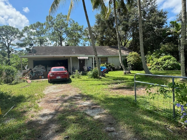 ranch-style home with a garage and a front lawn