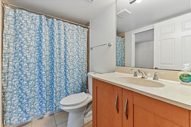 bathroom featuring vanity, tile patterned floors, and toilet