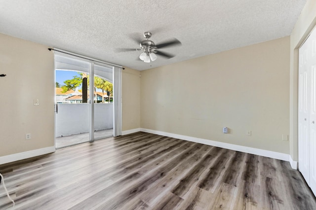 interior space featuring hardwood / wood-style flooring, ceiling fan, access to outside, and a textured ceiling