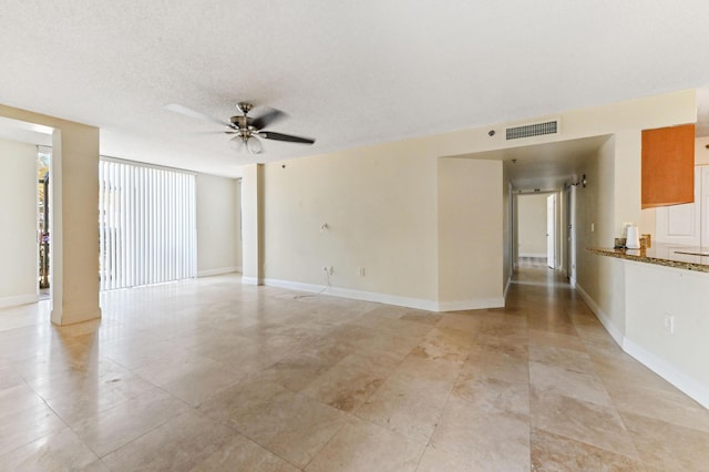 spare room featuring a textured ceiling and ceiling fan