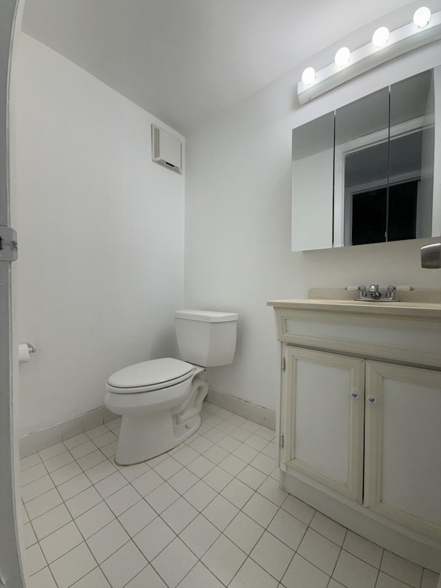 bathroom with vanity, tile patterned floors, and toilet