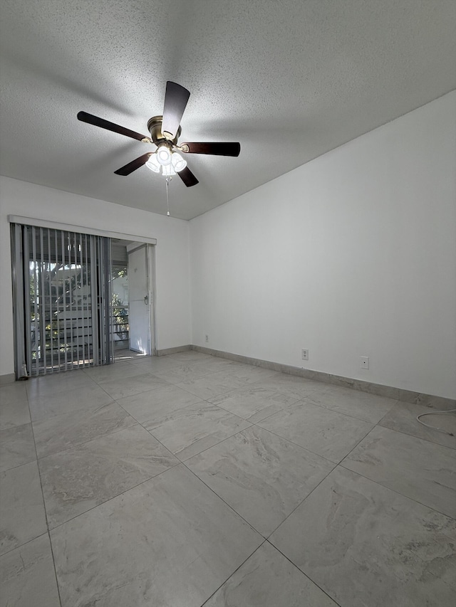 unfurnished room featuring ceiling fan and a textured ceiling